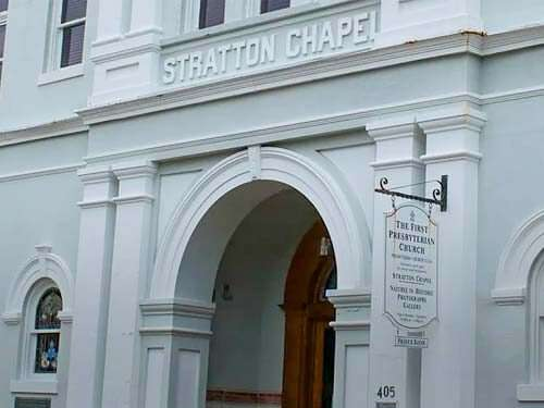 Stratton Chapel entrance, light blue building with arched doorway and sign, 435.